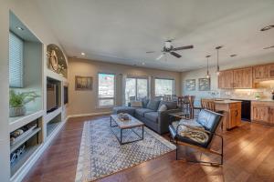 een grote woonkamer met een bank en een keuken bij Riverfront Perch, w Balcony over the River in Salida