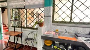 a small kitchen with a sink and a table at La Magia del Atardecer - Studio 02 in Santa Marta +5 photos