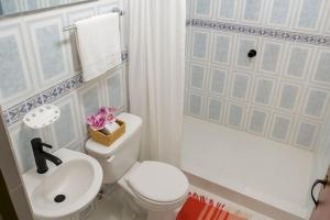a bathroom with a white toilet and a sink at La Magia del Atardecer - Studio 02 in Santa Marta