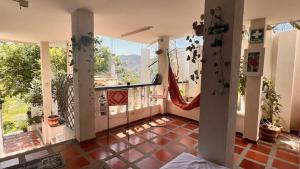a room with a balcony with a view of the mountains at La Magia del Atardecer - Studio 02 in Santa Marta