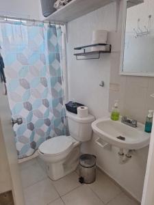 a bathroom with a toilet and a sink at Comfortable and nice house in Caucel in Mérida