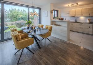 a kitchen and dining room with a table and chairs at Konny in Gaienhofen +10 photos