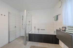 a bathroom with a bath tub and a shower at Konny in Gaienhofen