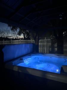 a jacuzzi tub in a backyard at night at Lehi High Luxe Views and Sky in Lehi