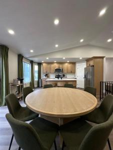 a large room with a table and chairs and a kitchen at Lehi High Luxe Views and Sky in Lehi