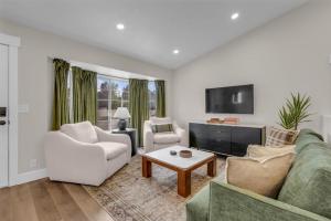 a living room with a couch and chairs and a tv at Lehi High Luxe Views and Sky in Lehi