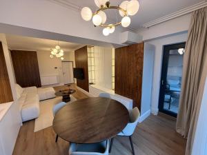 a living room with a table and chairs and a couch at Baneasa Panorama Lake in Bucharest
