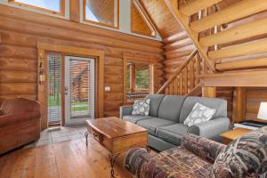 a living room with a couch and a table at Rustic Chalet Perfect Getaway for Groups in Golden