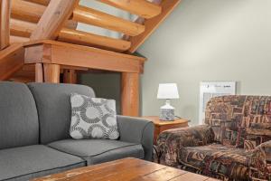 a living room with a couch and a chair at Rustic Chalet Perfect Getaway for Groups in Golden +24 photos