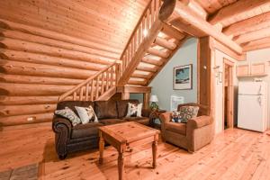 a living room with a couch and a table at Authentic, Timber Log Cabin Perfect for Groups in Golden