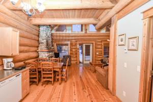 a dining room and kitchen in a log cabin at Authentic, Timber Log Cabin Perfect for Groups in Golden