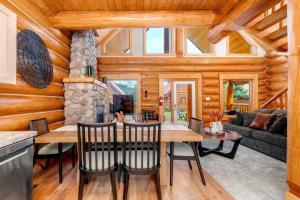 a dining room and living room with a table and chairs at Rustic Cabin Hideaway with BBQ Fire Pit and Mtn Views in Golden