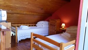 a bedroom with two beds in a attic at Appartements les Bressanes in Selonnet