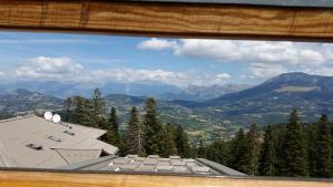 a view from a window of a house and mountains at Appartements les Bressanes in Selonnet