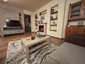 a living room with a coffee table and a fireplace at Oliver's House in Budaörs