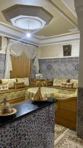 a living room with a couch and a table at Appartement in Benguerir