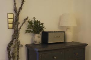 a night stand with a clock and a lamp on it at Chalet Alpl - Ferienwohnung Waldblick mit Sauna, Kamin & Whirlwanne in Hochrindl
