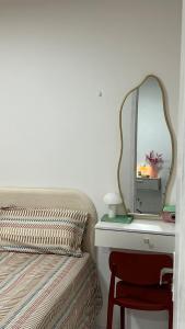 a bedroom with a bed and a mirror on a table at Apt 424 in João Pessoa