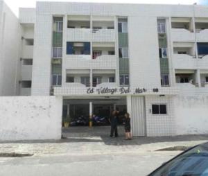 a man and a woman standing in front of a building at Apt 424 in João Pessoa