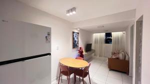 a room with a table and chairs and a living room at Apt 424 in João Pessoa