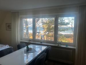 a room with two windows and a table and chairs at Seepferdchen in Timmendorfer Strand