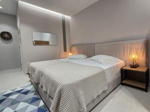 a bedroom with a bed and a lamp on a table at Elite Guesthouse in Tirana