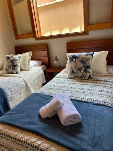 une paire de lits avec une serviette dessus dans l'établissement Recanto no Centro, à São Francisco Xavier