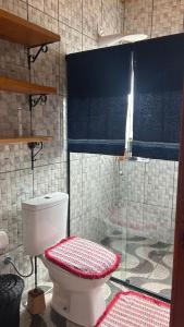 a bathroom with a toilet and a shower at Casa da Barra in Ubatuba +26 photos