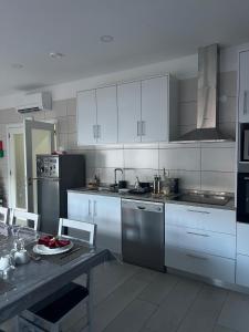a kitchen with white cabinets and a table with a plate at Casa da Moagem in Vinhais +39 photos