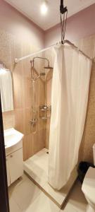 a bathroom with a shower with a shower curtain at Confort Flat in Braşov +18 photos