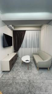 a living room with a couch and a table at Kamoli Khujandi 166 in Khujand