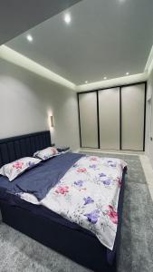 a bedroom with a large bed in a room at Kamoli Khujandi 166 in Khujand +8 photos