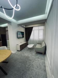 a living room with a couch and a table at Kamoli Khujandi 166 in Khujand