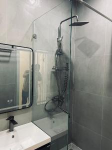 a bathroom with a shower and a sink and a mirror at Kamoli Khujandi 166 in Khujand +8 photos
