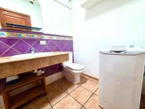 a bathroom with a sink and a toilet at Famara Chill House in Famara