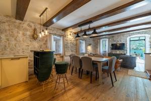 a kitchen and dining room with a table and chairs at Seafront Kotor Bay View Villa NW in Muo