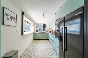 a kitchen with a refrigerator and a sink at Seafront Kotor Bay View Villa NW in Muo