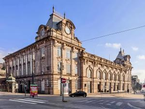 a large building with a clock tower on top of it at Feel Porto in Bolhão "Metro at your doorstep" in Porto