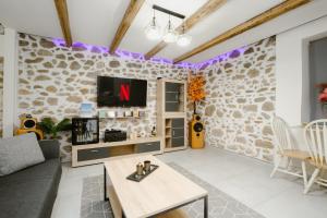 a living room with a stone wall at luxury house in Ierapetra