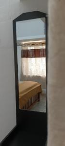 a mirror reflection of a bed in a room at AI cube Homes in Pīrmed +2 photos