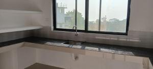 a kitchen with a sink and a window at AI cube Homes in Pīrmed