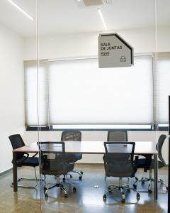 a conference room with a table and chairs in front of a window at Hotel Dublé in Navojoa +27 photos