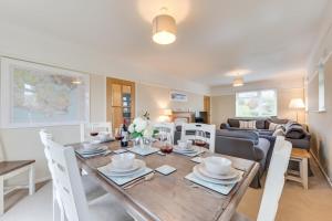 a dining room and living room with a table and chairs at 4 Bed in Langton Matravers oc-wy548 in Langton Matravers