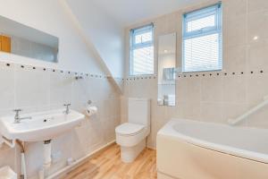 a white bathroom with a sink and a toilet at 4 Bed in Langton Matravers oc-wy548 in Langton Matravers