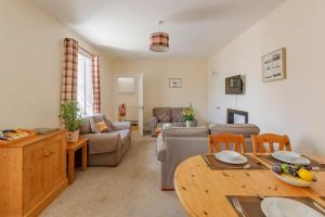 a living room with a couch and a table at 3 Bed in Drummore oc-k30214 in Drummore