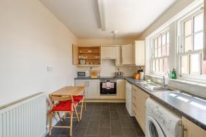 a kitchen with a sink and a table with red chairs at 3 Bed in Drummore oc-k30214 in Drummore +20 photos