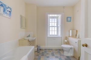 a bathroom with a tub and a toilet and a sink at 3 Bed in Drummore oc-k30214 in Drummore