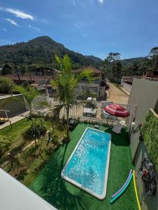 an image of a swimming pool on the balcony of a house at Chalé do Gaúcho in Ubatuba