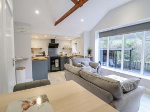 a living room with a couch and a table at Lodge at Nadur in Machynlleth