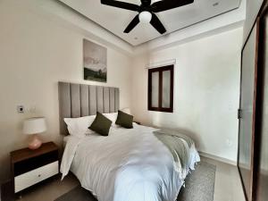 a bedroom with a large bed with a ceiling fan at OVATA 401- Zona Romántica in Puerto Vallarta